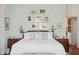 Light-filled main bedroom featuring framed art above the bed and a view to an adjoining room at 15 Rutledge Ave, Charleston, SC 29401