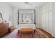 Bright main bedroom with a canopy bed, hardwood floors, and natural light at 15 Rutledge Ave, Charleston, SC 29401