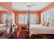 Spacious main bedroom bathed in natural light features wood floors and a decorative ceiling fan at 15 Rutledge Ave, Charleston, SC 29401