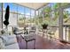 Inviting screened patio with comfortable seating and tile flooring at 15 Rutledge Ave, Charleston, SC 29401
