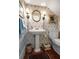 Powder room with pedestal sink, decorative wallpaper, and attractive decor at 15 Rutledge Ave, Charleston, SC 29401