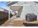 Covered backyard area with a concrete floor, a grill and a small birdhouse mounted on a white column at 150 Midtown Ave, Summerville, SC 29486