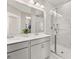 Modern bathroom featuring double sinks, a large mirror, and a glass-enclosed shower with marble tile at 150 Midtown Ave, Summerville, SC 29486