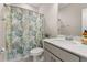 Relaxing bathroom featuring a toilet, vanity with a sink, and a tropical-themed shower curtain at 150 Midtown Ave, Summerville, SC 29486