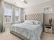 This is a beautiful bedroom with many windows, light colored walls, and a large, tufted headboard at 150 Midtown Ave, Summerville, SC 29486