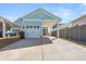Exterior shot of home featuring a long driveway and attached garage with covered parking at 150 Midtown Ave, Summerville, SC 29486
