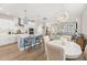 Modern kitchen open to the dining area, featuring white cabinets and a large central island at 150 Midtown Ave, Summerville, SC 29486