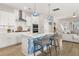 Modern kitchen featuring white cabinets, stainless steel appliances, and island with seating at 150 Midtown Ave, Summerville, SC 29486