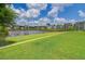 Picturesque pond view with manicured lawns and charming homes creating a serene community setting at 150 Midtown Ave, Summerville, SC 29486