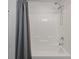 Bright white bathroom features tiled walls, and a shower with a multi-setting shower head at 1589 Bluewater Way, Charleston, SC 29414