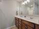 Bathroom featuring double sinks, wooden cabinets, and a large mirror above the vanity at 1589 Bluewater Way, Charleston, SC 29414
