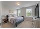 Comfortable bedroom with two windows, a bed, and a modern dresser at 1589 Bluewater Way, Charleston, SC 29414
