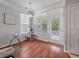 Bright dining area with wood floors, a door to outside, and a pet play center at 1589 Bluewater Way, Charleston, SC 29414