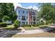 View of townhomes with manicured landscaping, blue and brown accents, and a welcoming entryway at 1589 Bluewater Way, Charleston, SC 29414