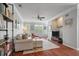 Bright living room featuring hardwood floors, comfortable seating, and large windows at 1589 Bluewater Way, Charleston, SC 29414