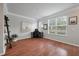 A bright living room with hardwood floors, a work area, and neutral wall colors at 1589 Bluewater Way, Charleston, SC 29414