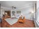 Open-concept living room with hardwood floors, neutral decor, and seamless flow to kitchen at 1589 Bluewater Way, Charleston, SC 29414