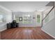 Open-concept living room with hardwood floors, ample natural light, and a work area at 1589 Bluewater Way, Charleston, SC 29414