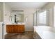 Well-lit bathroom with double vanity, glass shower, and soaking tub at 167 Decatur Dr, Summerville, SC 29486