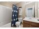 Cozy bathroom features a shower-tub combo with blue shower curtain and a wood vanity with a white sink at 167 Decatur Dr, Summerville, SC 29486