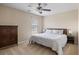Light bedroom with ceiling fan features a plush bed with fluffy pillows and neutral walls at 167 Decatur Dr, Summerville, SC 29486