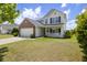 Attractive two-story home featuring a brick front, green lawn and inviting porch at 167 Decatur Dr, Summerville, SC 29486