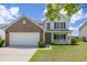 Charming two-story home with a brick facade, a well-manicured lawn, and a welcoming front porch at 167 Decatur Dr, Summerville, SC 29486