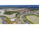 Aerial view of new construction community around a lake, with pool and clubhouse at 185 Whaler Ave, Summerville, SC 29486