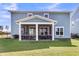 A spacious backyard with a screened-in porch, manicured lawn, and privacy fence at 185 Whaler Ave, Summerville, SC 29486