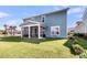Spacious backyard featuring a screened-in porch, well-maintained lawn, and a charming garden bed at 185 Whaler Ave, Summerville, SC 29486