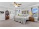 Spacious bedroom with a ceiling fan, tray ceiling, carpet floors, decor, and natural light at 185 Whaler Ave, Summerville, SC 29486