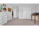 A well lit, minimalist-decorated bedroom features neutral walls, carpet floors, and multiple doors at 185 Whaler Ave, Summerville, SC 29486