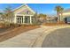 Modern community clubhouse with large windows, landscaping, and a sidewalk leading to the entrance at 185 Whaler Ave, Summerville, SC 29486