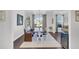 Bright dining area featuring a large wooden table, bench seating, and elegant decor at 185 Whaler Ave, Summerville, SC 29486
