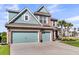 Attractive two-story home with a three-car garage, brick accents, and lush landscaping for a welcoming facade at 185 Whaler Ave, Summerville, SC 29486