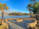 Scenic fire pit area by the lake, a perfect outdoor spot for cozy evenings with friends and Gathering at 185 Whaler Ave, Summerville, SC 29486