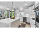 Spacious kitchen boasts a center island, stainless steel appliances, and access to outdoor views at 185 Whaler Ave, Summerville, SC 29486