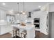 Modern kitchen features white cabinetry, stainless steel appliances, and a center island with seating at 185 Whaler Ave, Summerville, SC 29486