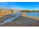 A wooden pier extends into the calm lake near a lakeside home at 185 Whaler Ave, Summerville, SC 29486