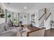 Bright living room with hardwood floors, staircase and a decorative wreath on the door at 185 Whaler Ave, Summerville, SC 29486