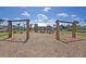 Community playground featuring swings and a play structure, set among beautiful palm trees and landscaping at 185 Whaler Ave, Summerville, SC 29486