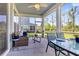 Inviting screened porch with stylish furniture, ceiling fan, and view of the landscaped backyard at 185 Whaler Ave, Summerville, SC 29486
