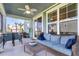 Relaxing screened porch with comfortable seating and a ceiling fan, perfect for outdoor entertaining at 185 Whaler Ave, Summerville, SC 29486