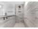 Modern shower featuring gray-patterned tile, a rain shower head, a shower niche, and a glass divider at 185 Whaler Ave, Summerville, SC 29486