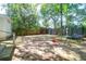 Spacious backyard featuring a swing set, trampoline, shed, and wooden fence, perfect for outdoor activities at 1920 Iris St, North Charleston, SC 29405