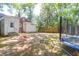 A spacious backyard featuring a trampoline and swing, with a shed and wooden fence surrounding the property at 1920 Iris St, North Charleston, SC 29405