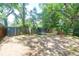 Expansive backyard with a trampoline, swing, storage shed, and wooden fence, great for outdoor fun and storage at 1920 Iris St, North Charleston, SC 29405