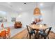 Open dining area with hardwood floors, a modern light fixture and a sitting space at 1920 Iris St, North Charleston, SC 29405