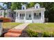Charming white two-story home with a inviting front porch and landscaped yard at 1920 Iris St, North Charleston, SC 29405