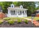 Charming white two-story home with a welcoming front porch and well-maintained lawn at 1920 Iris St, North Charleston, SC 29405